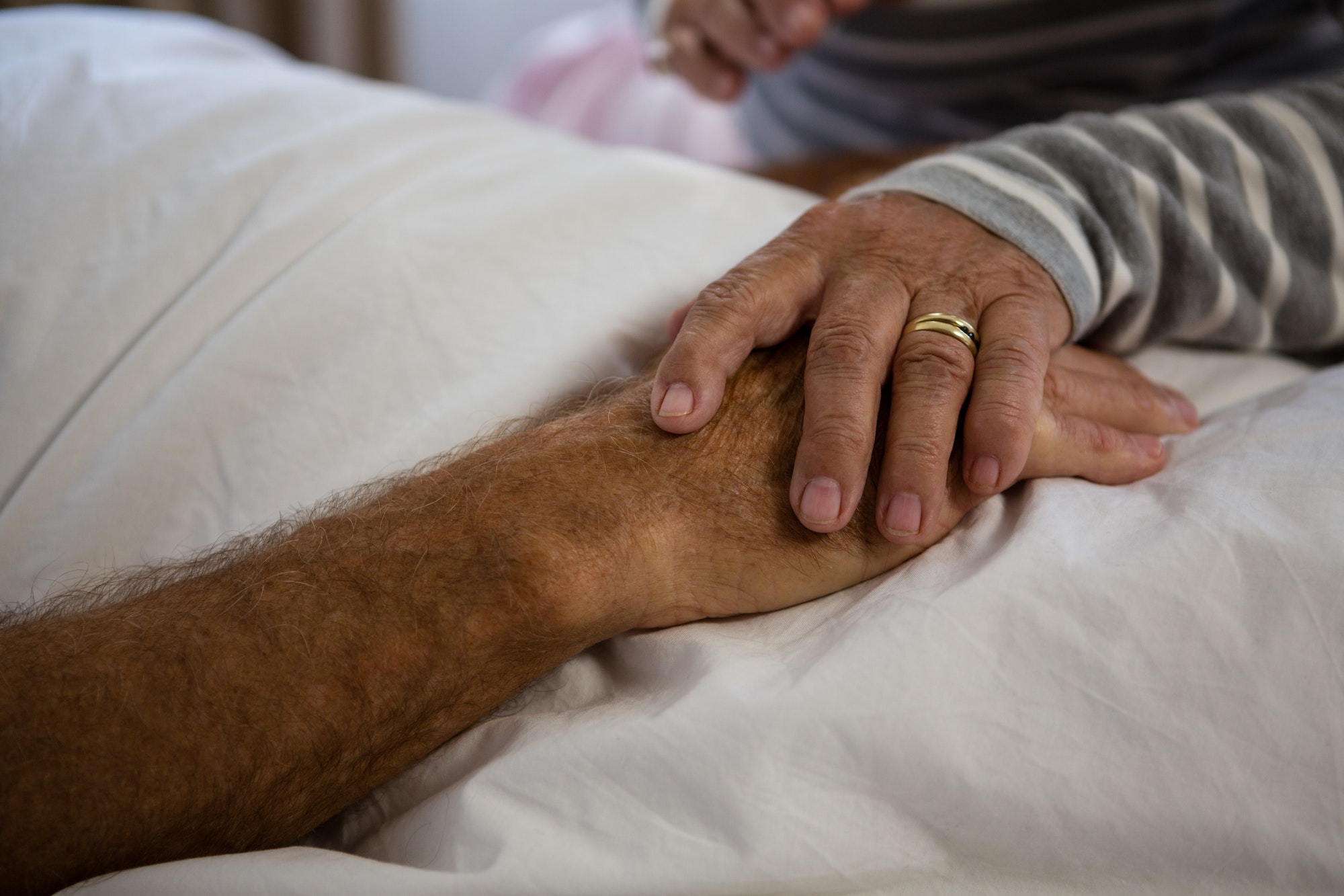 Hands of senior couple relaxing in nursing home